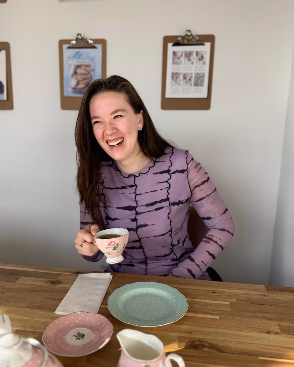 Marina Immonen laughing over a cup of tea