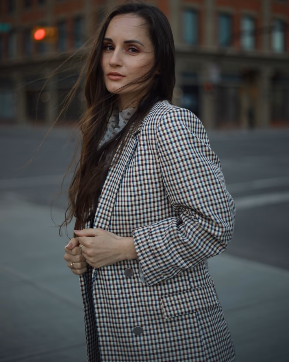 Mariya Herasymenko in a check blazer on a city street
